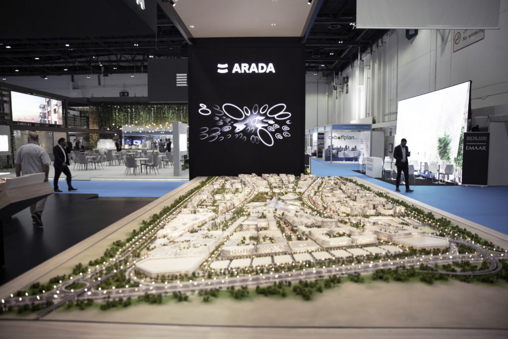 Perspective of the Arada stand at Cityscape Global 2019 showing the Aljada masterplan model