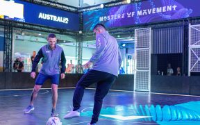 Tim Cahill and Maxi Rodriguez playing on the interactive Visa pitch